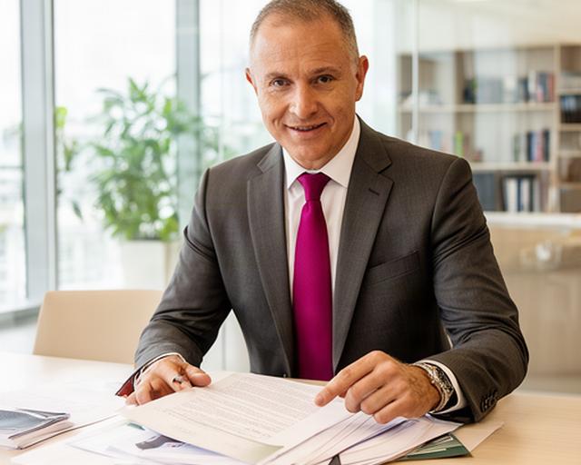 Singapore managing partner reviewing corporate documents in a bright law office